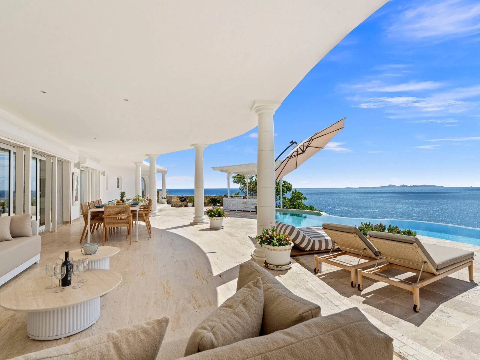 Covered terrace lounge overlooking the pool