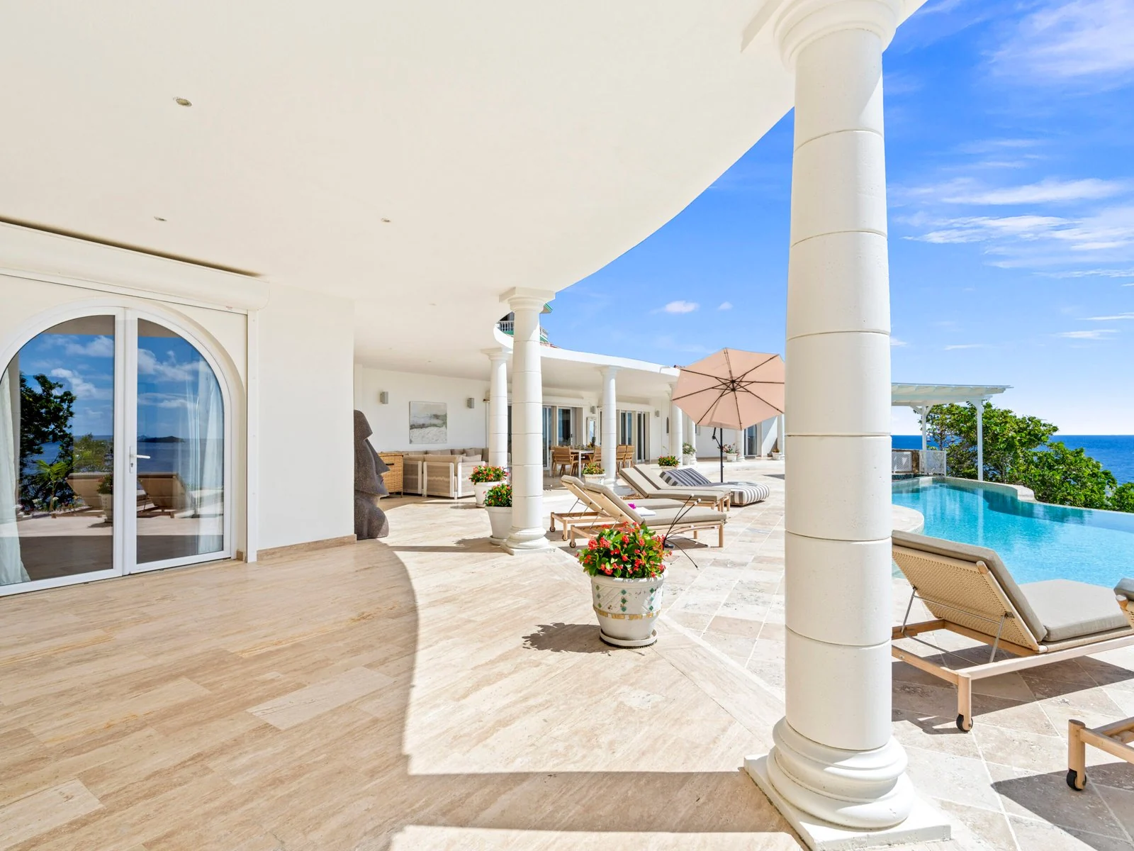 Covered terrace lounge overlooking the pool