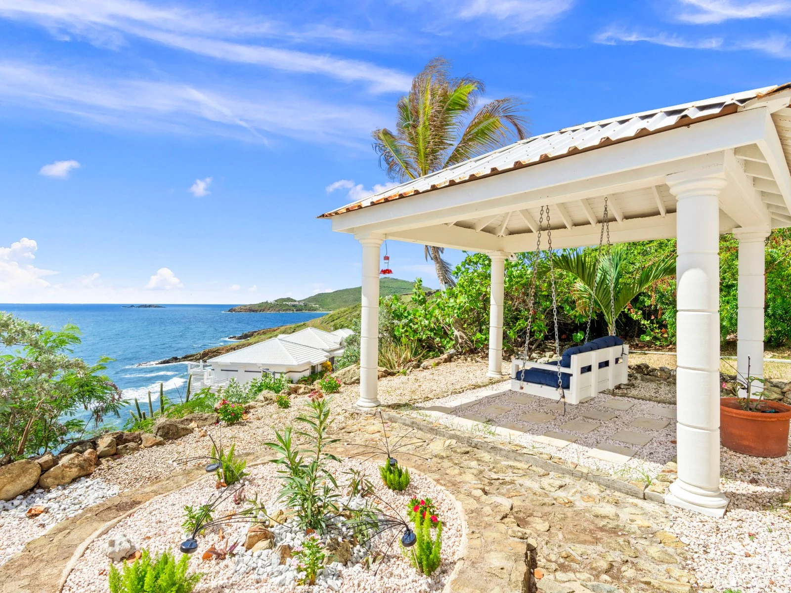Garden gazebo with swinging bench and ocean views