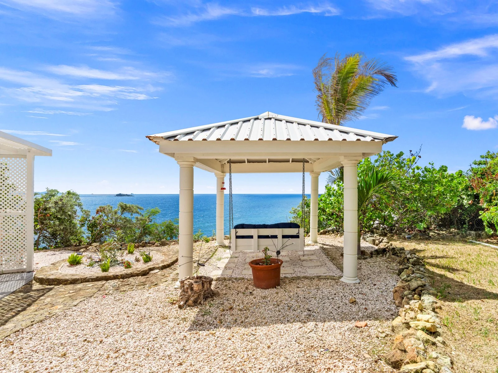 Garden gazebo with swinging bench and ocean views