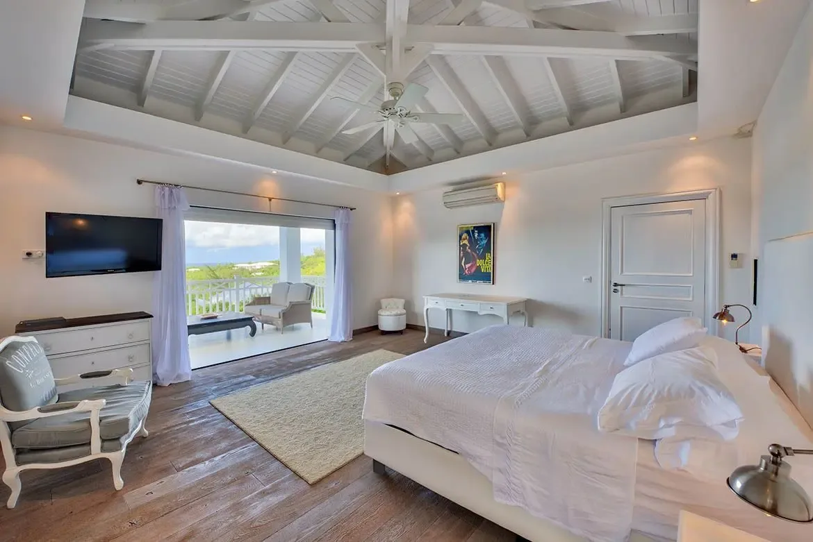 Wake up to breathtaking ocean views from this vaulted-ceiling master suite — pure Caribbean luxury.