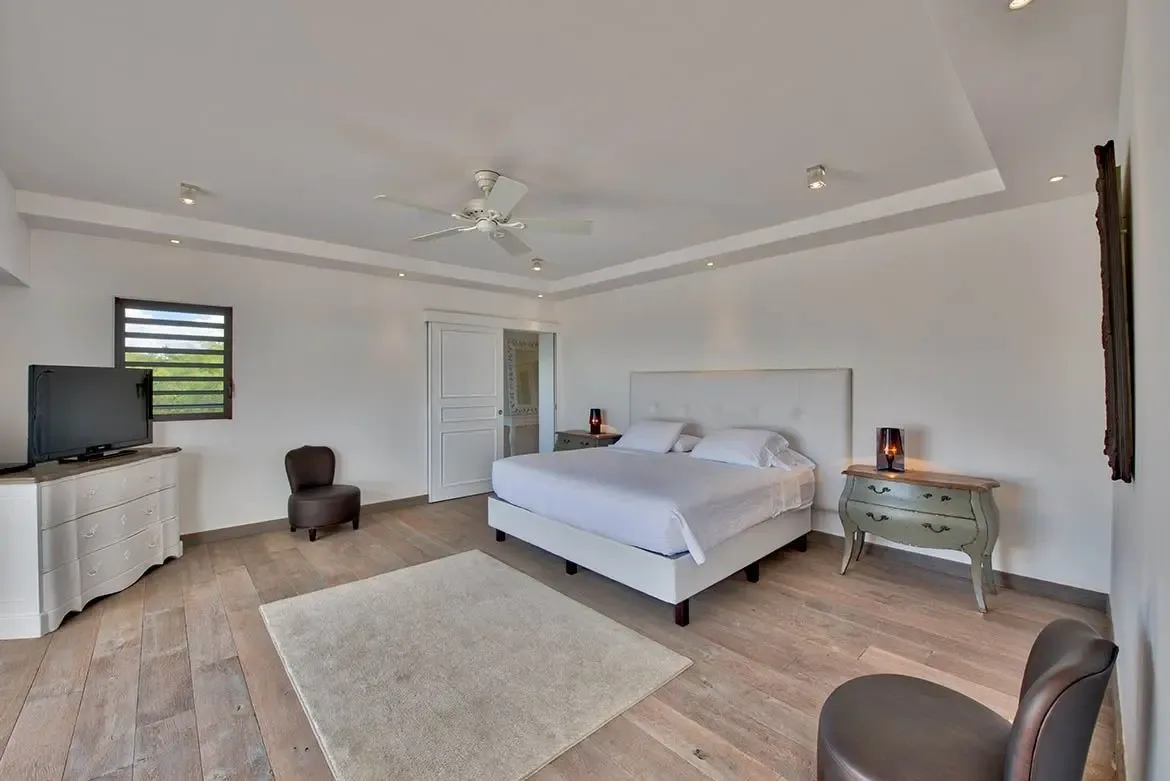 Tropical accents and private bathroom access in this charming bedroom.