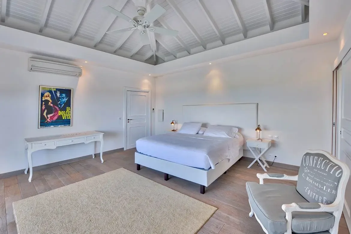 High ceilings and natural light define this elegant bedroom retreat.