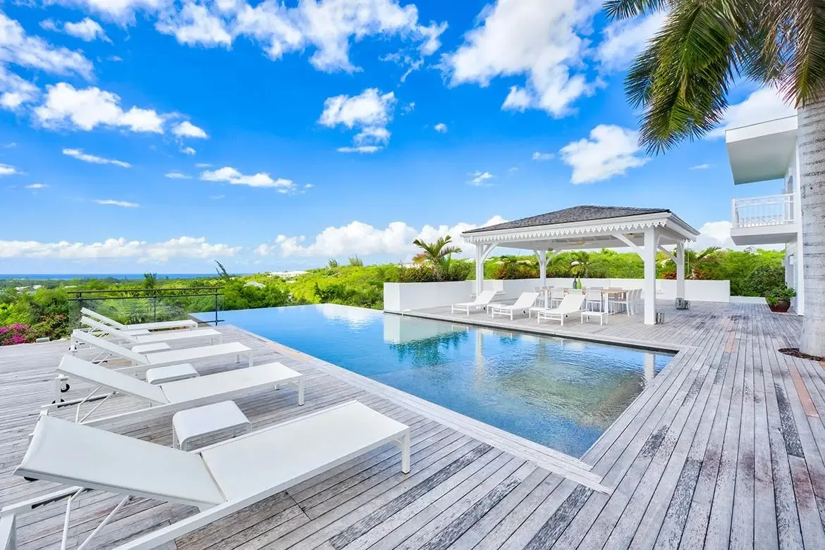 Infinity-edge pool with covered gazebo — your private paradise awaits.