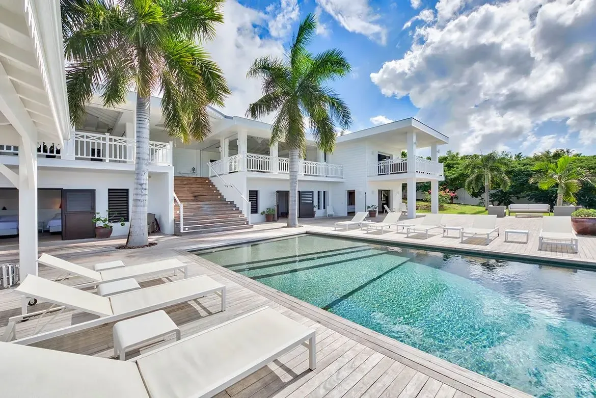 Palm-fringed pool deck under brilliant blue skies — postcard perfection.