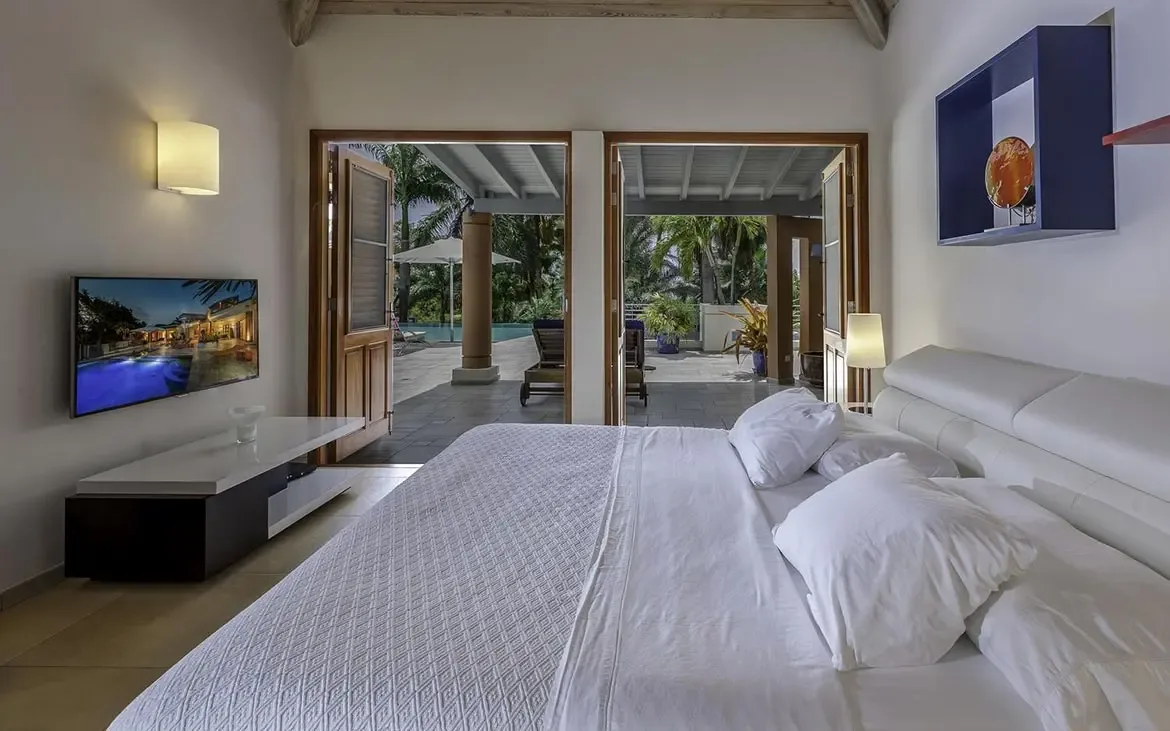 Warm wooden accents enhance this bedroom with private bathroom access.