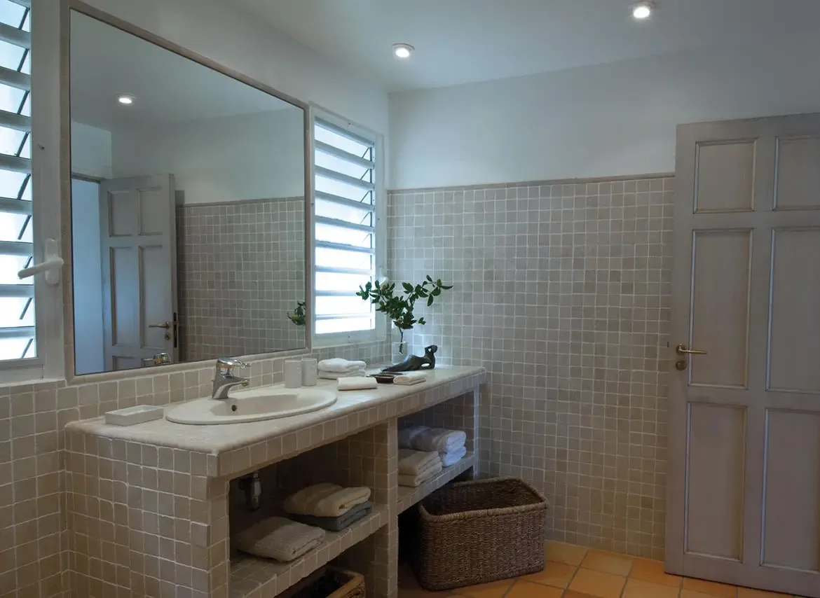 Elegant vanity with natural light and woven storage.