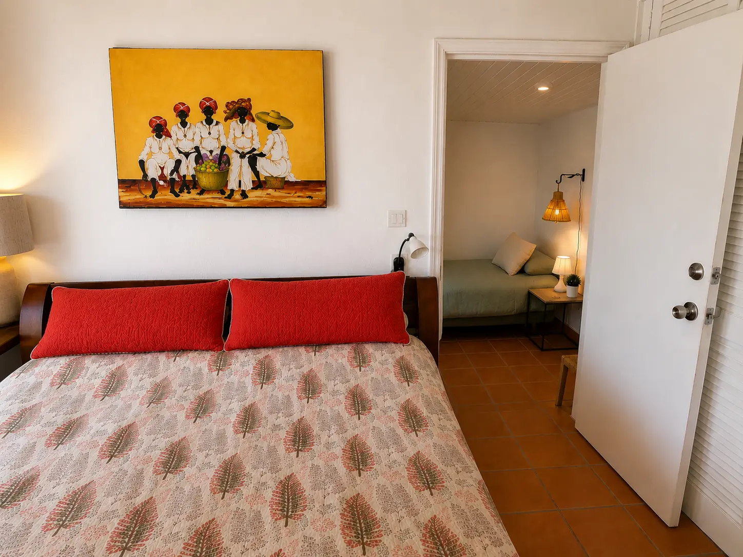 Bedroom 1 features warm wood furnishings and colorful island artwork.