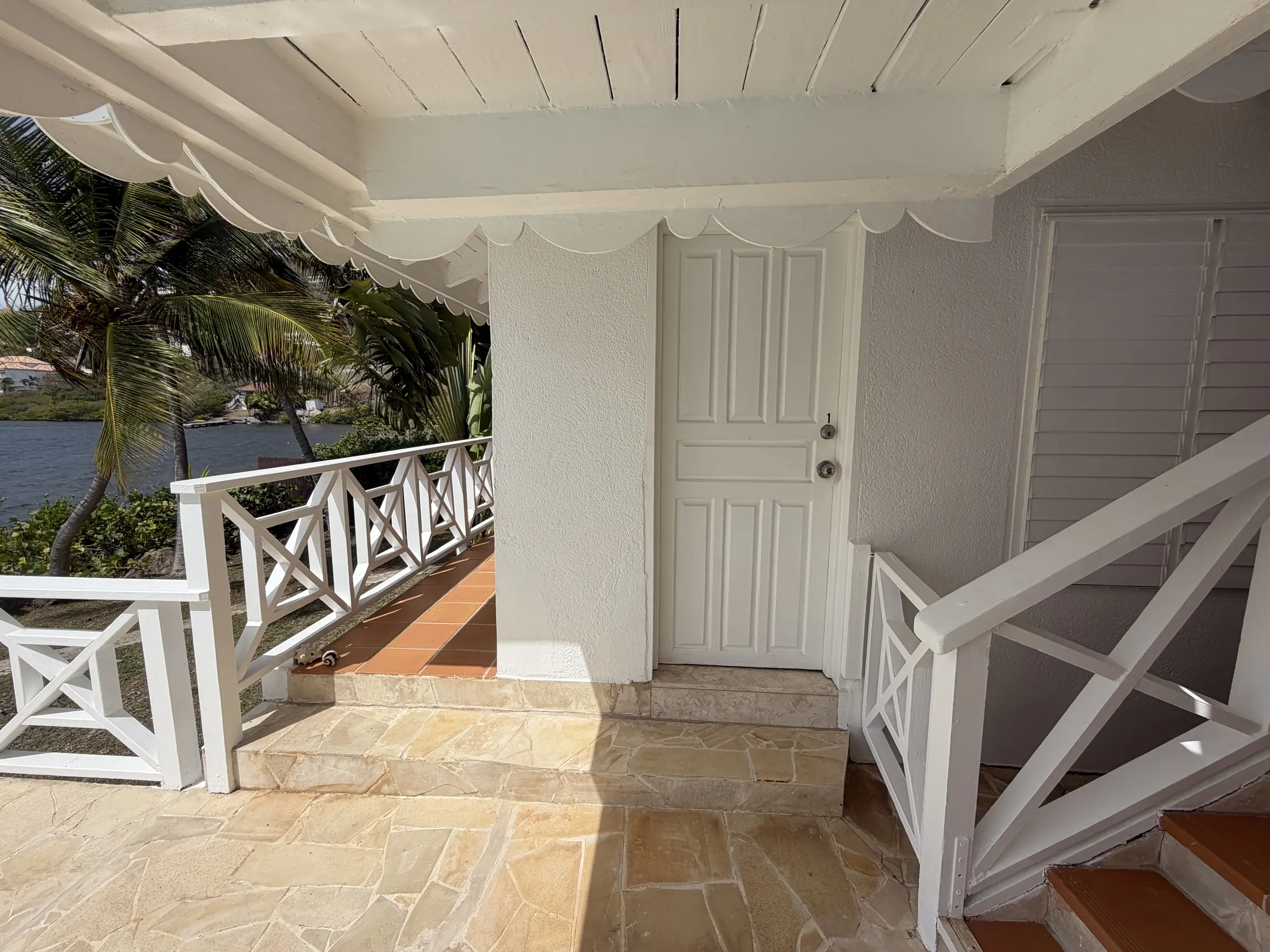 Private exterior access to Bedroom 1 from the poolside terrace.