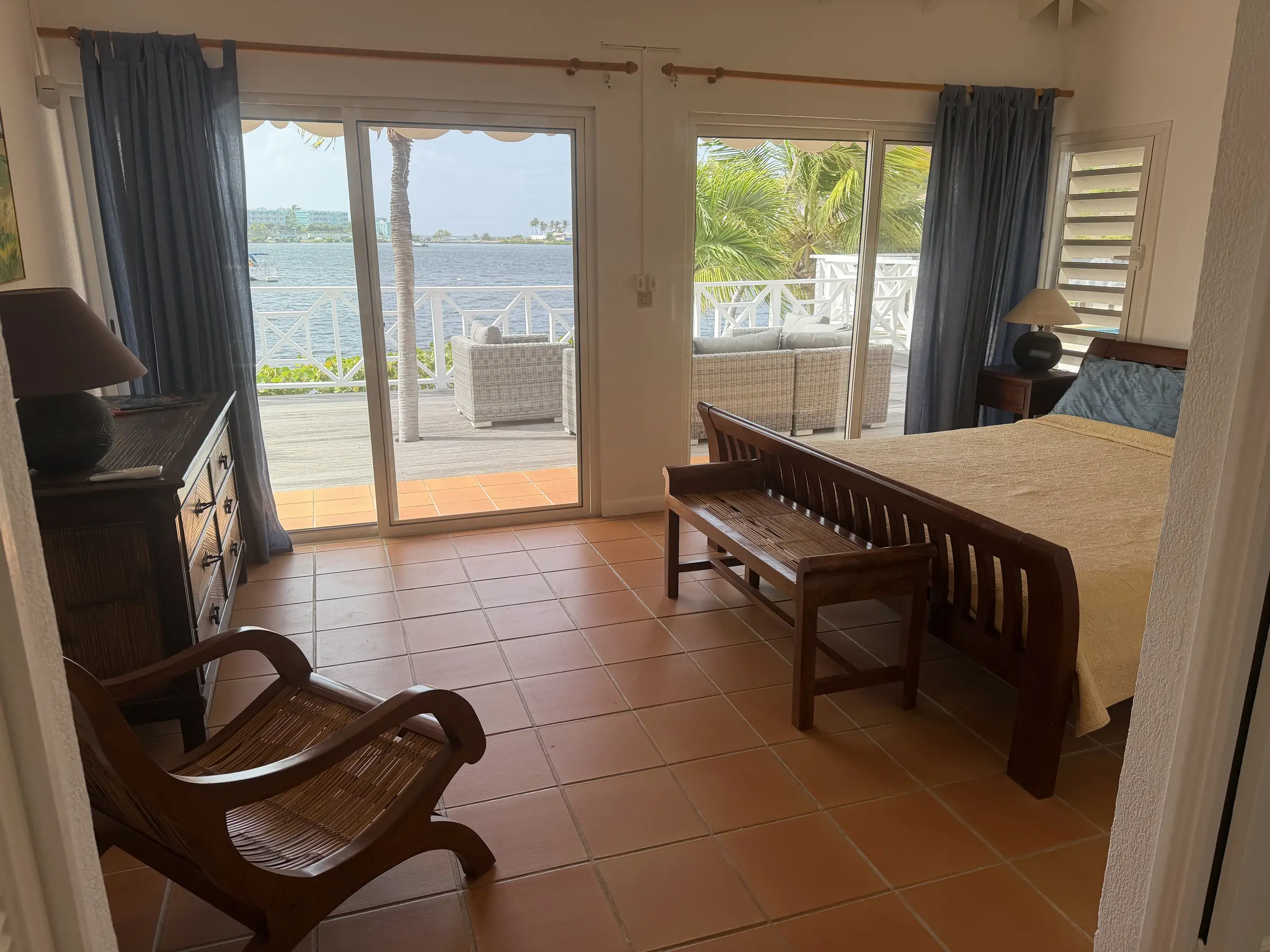 Bedroom 2 opens directly to its waterfront balcony.