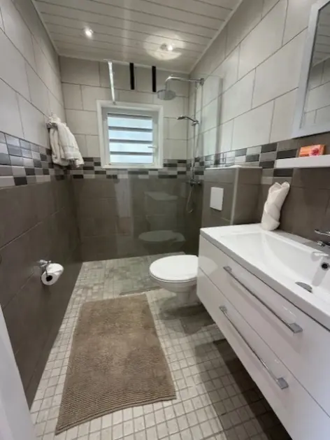 Private en-suite bathroom for Bedroom 2 with a walk-in shower.