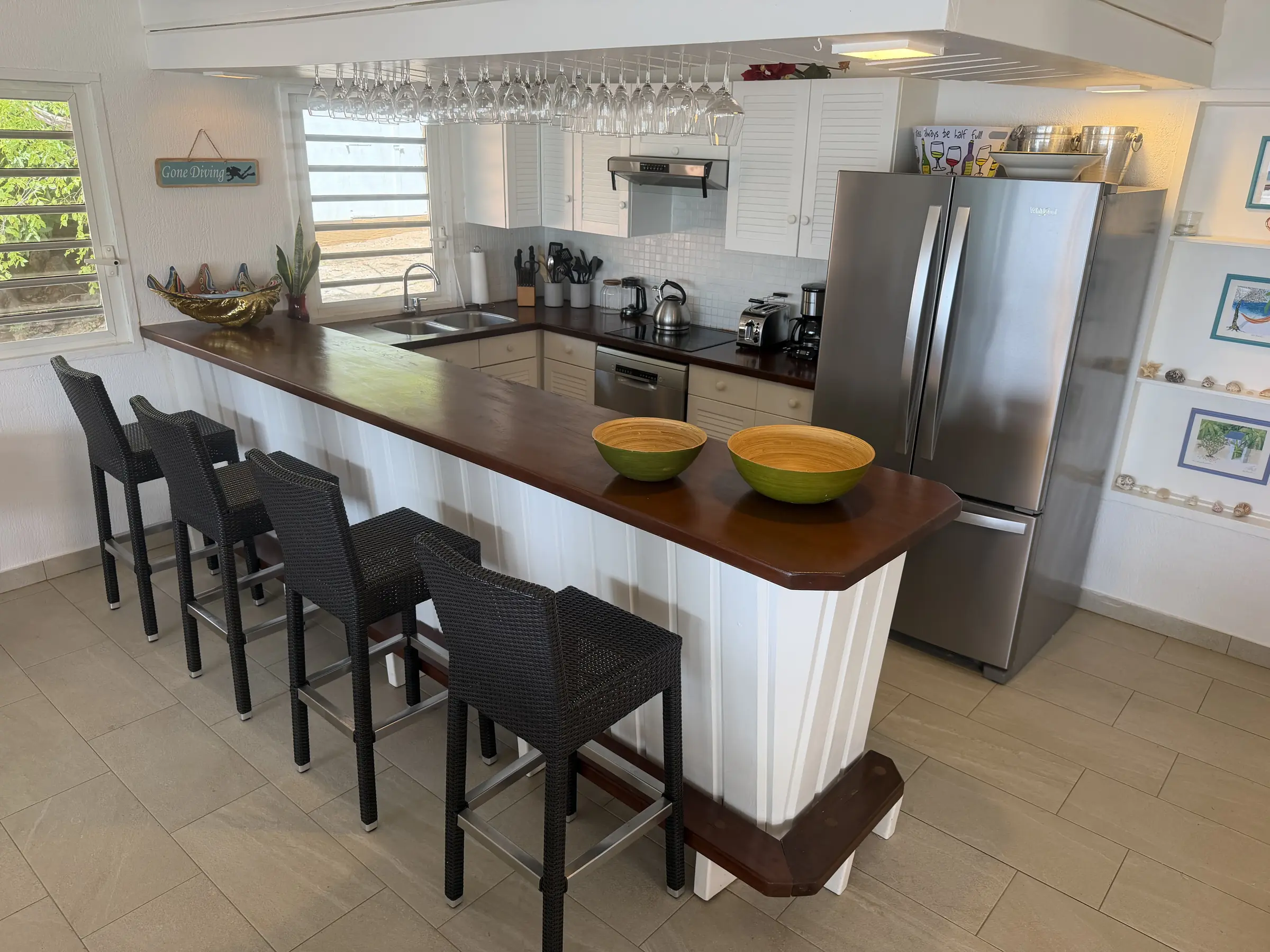 Open kitchen with a generous breakfast bar and seating for casual meals.
