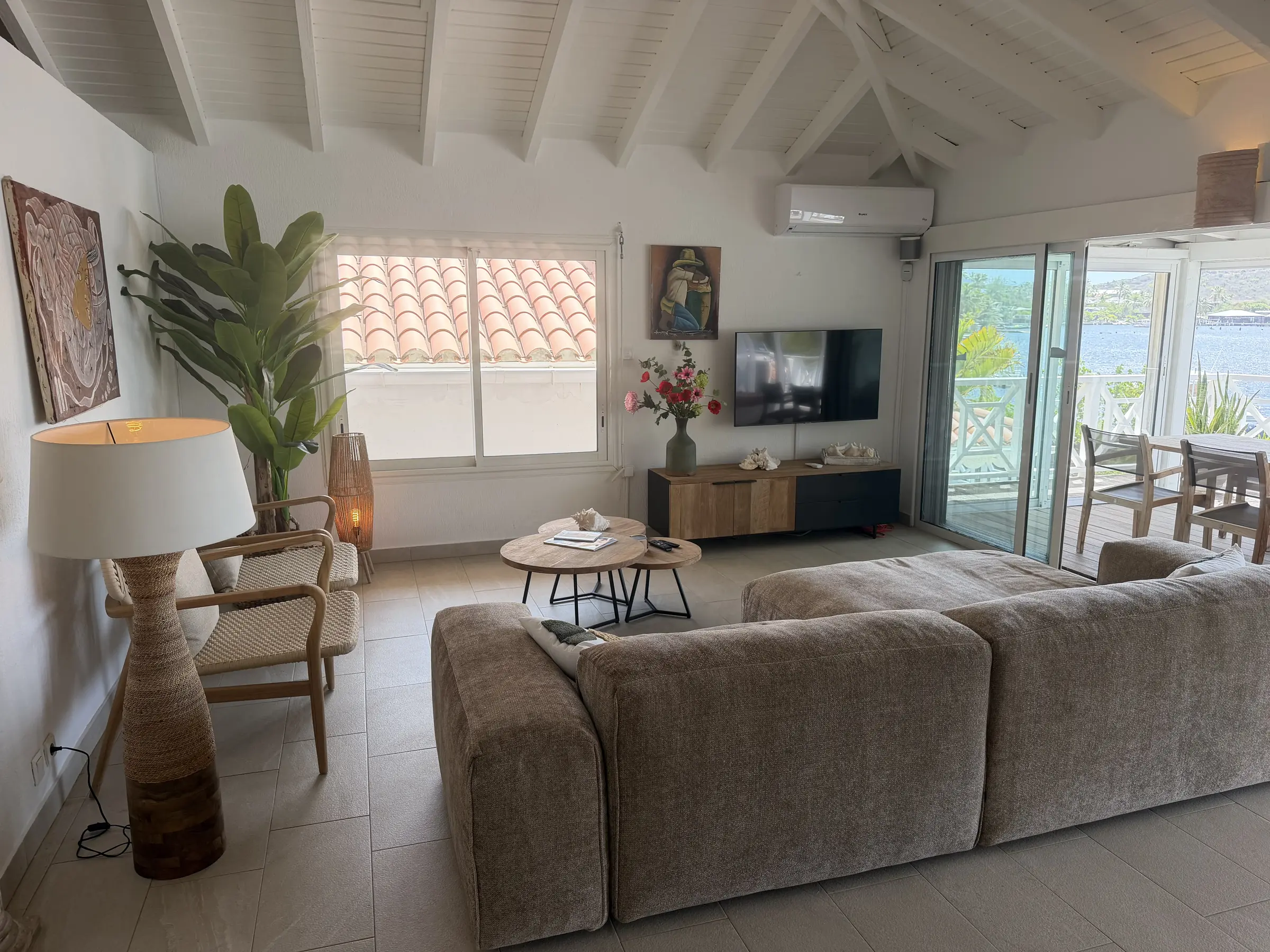 Comfortable living room opening toward the waterfront terrace.