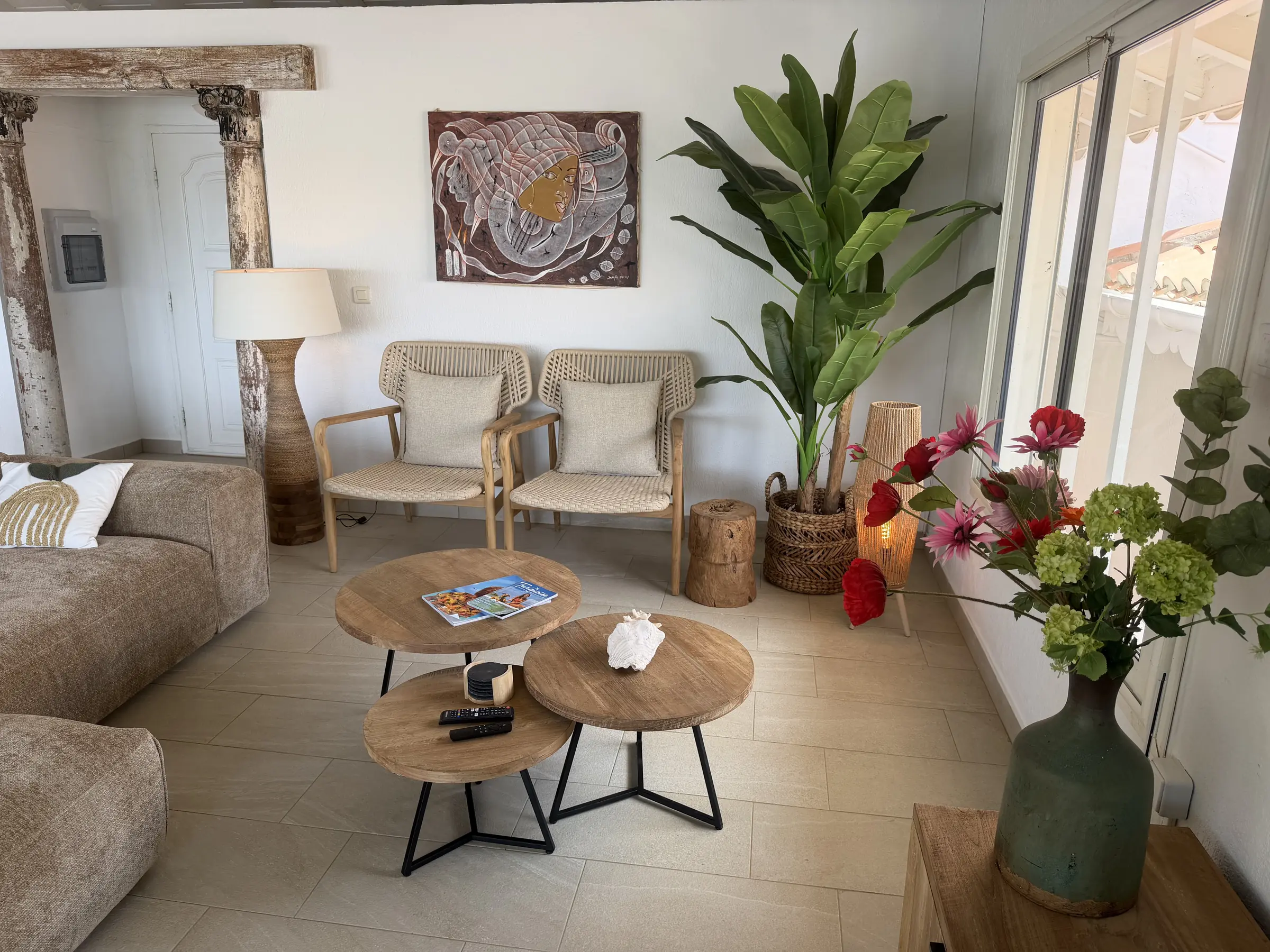 Villa Coralita's living room with warm natural textures and tropical accents.