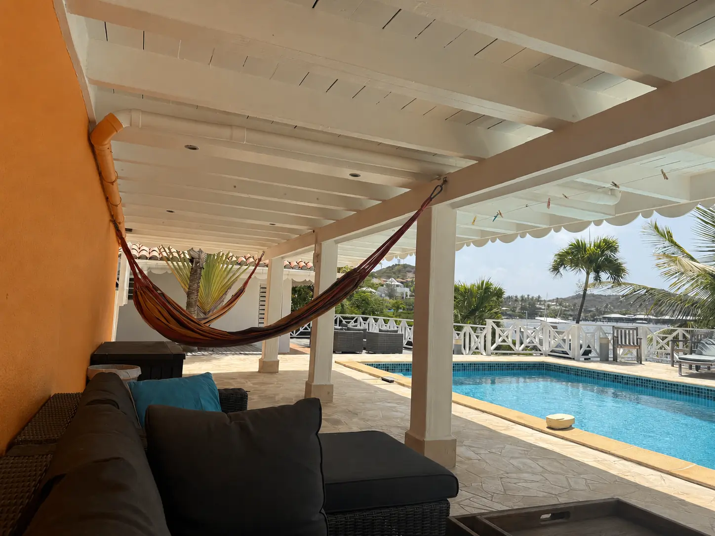 Covered poolside lounge with a hammock and direct access to the terrace.