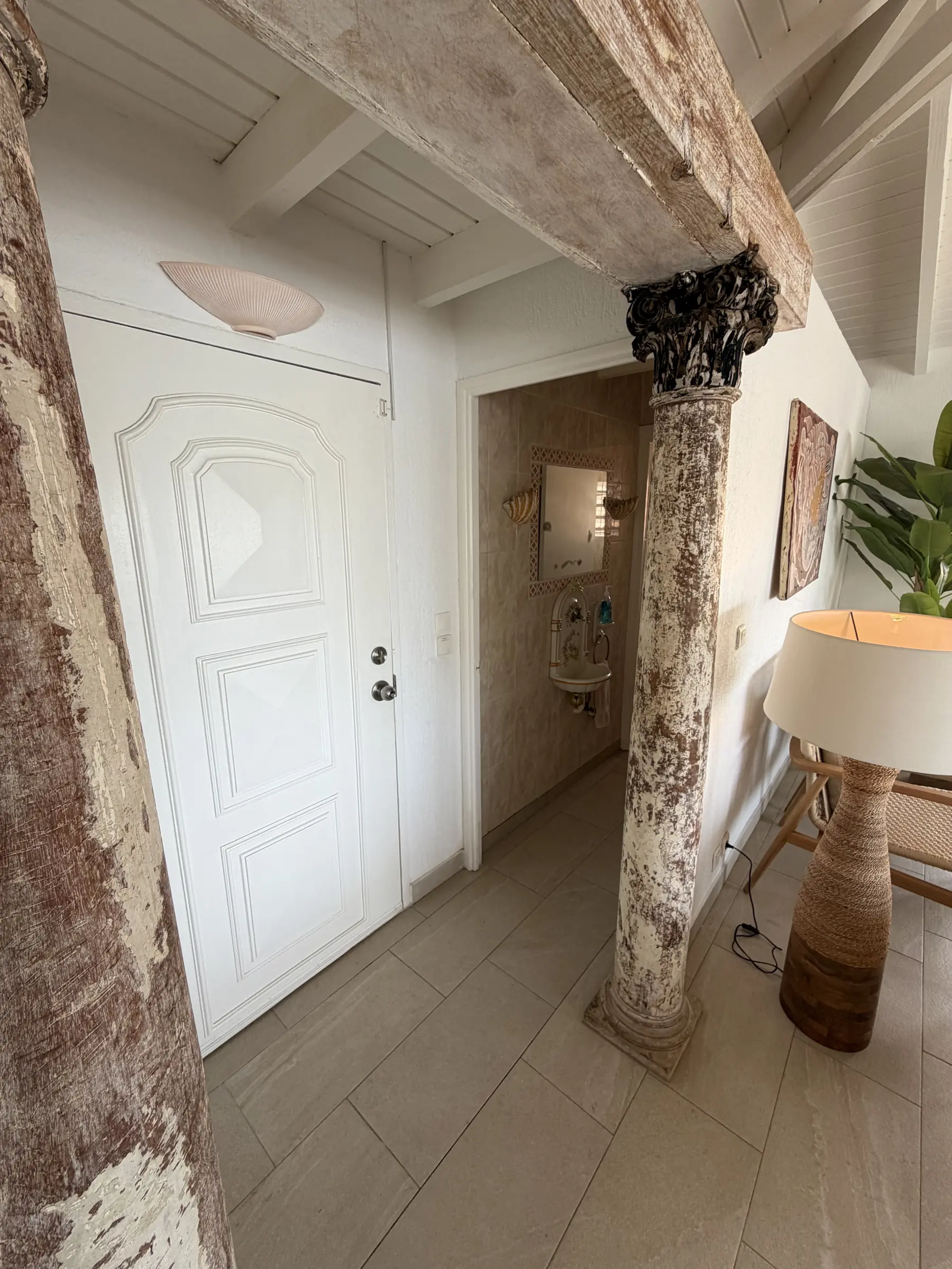 Stone columns frame the covered entrance to Villa Coralita.