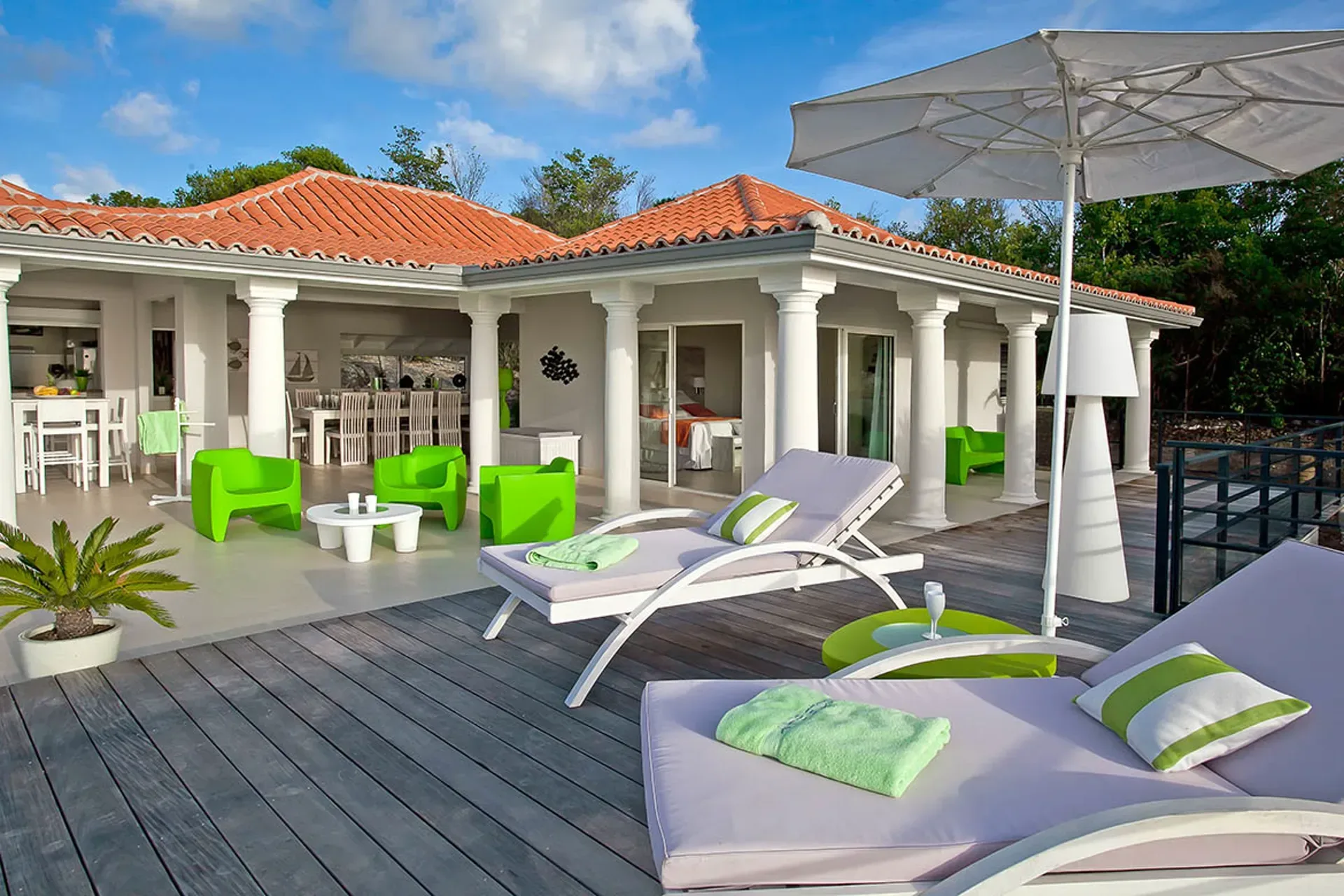 Terrace deck with loungers and green accents.