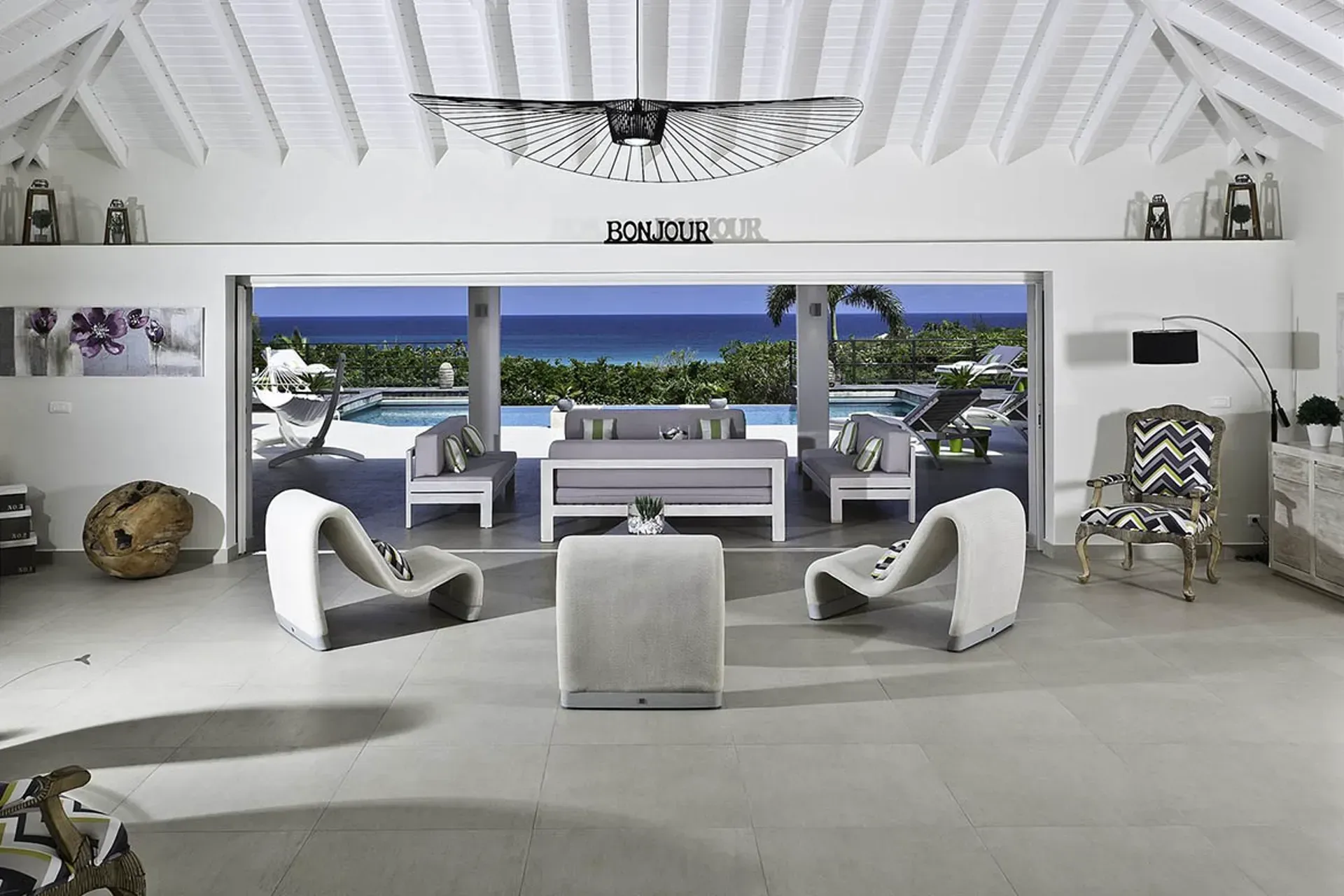 Spacious open-concept living room with seamless indoor-outdoor flow and ocean views.