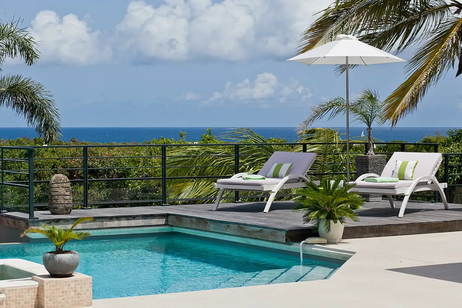 Pool with jacuzzi and outdoor living areas.