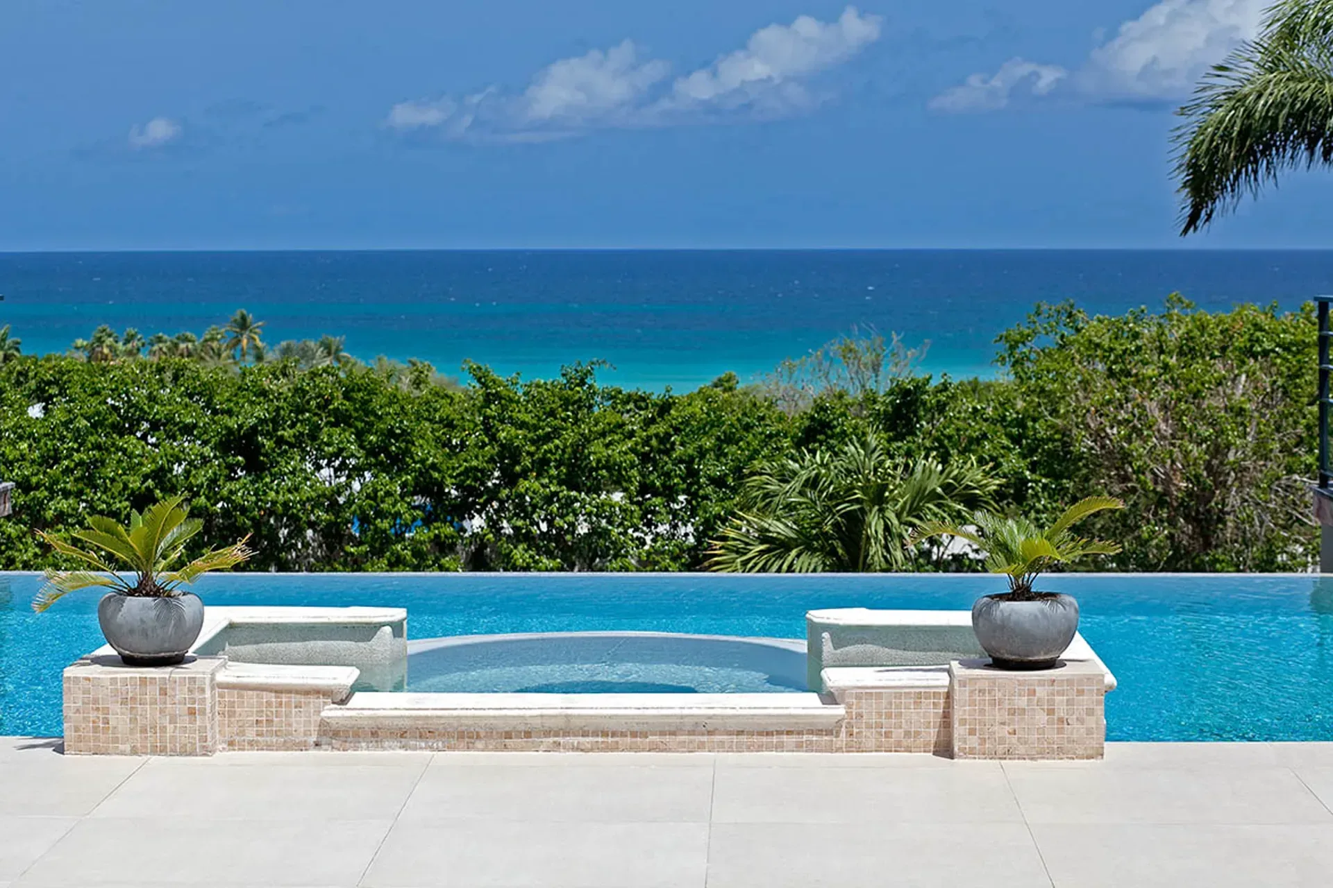 Main pool and terrace with Mediterranean architecture.
