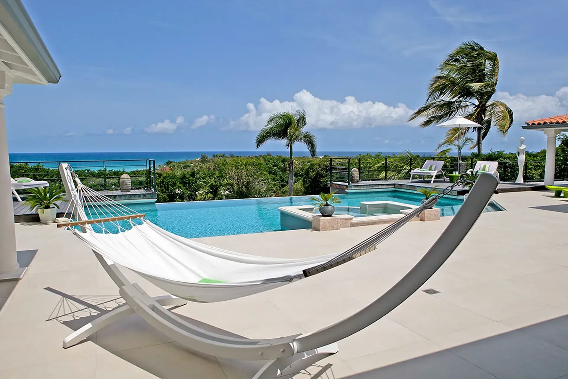 Terrace and pool with Mediterranean villa views.