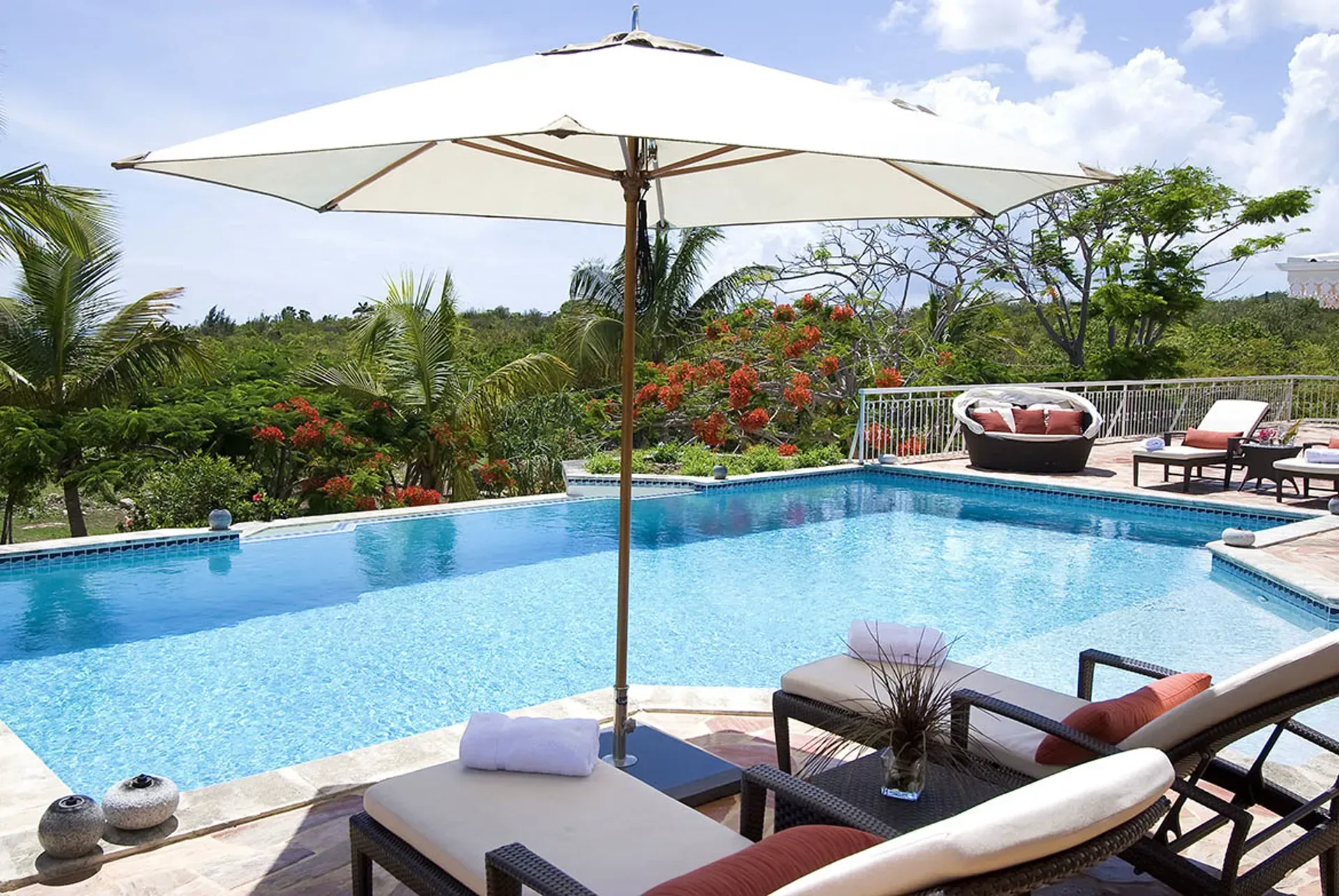 The villa exterior blends beautifully with tropical surroundings.