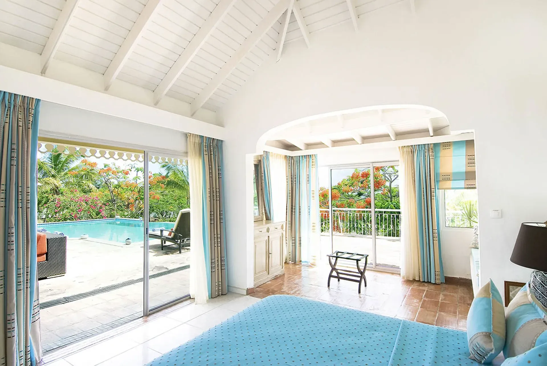 Dine al fresco by the pool where elegant outdoor living meets Caribbean charm.