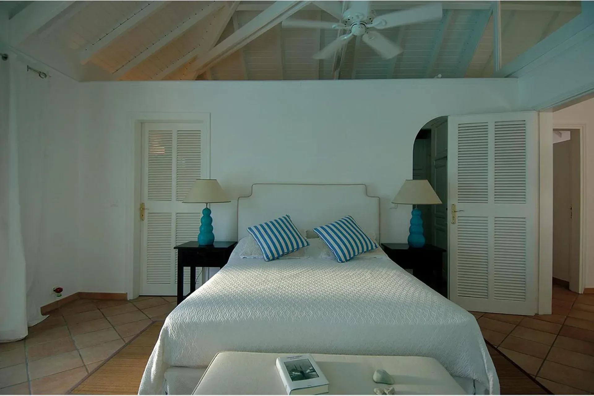 The villa exterior showcases elegant Caribbean architecture.