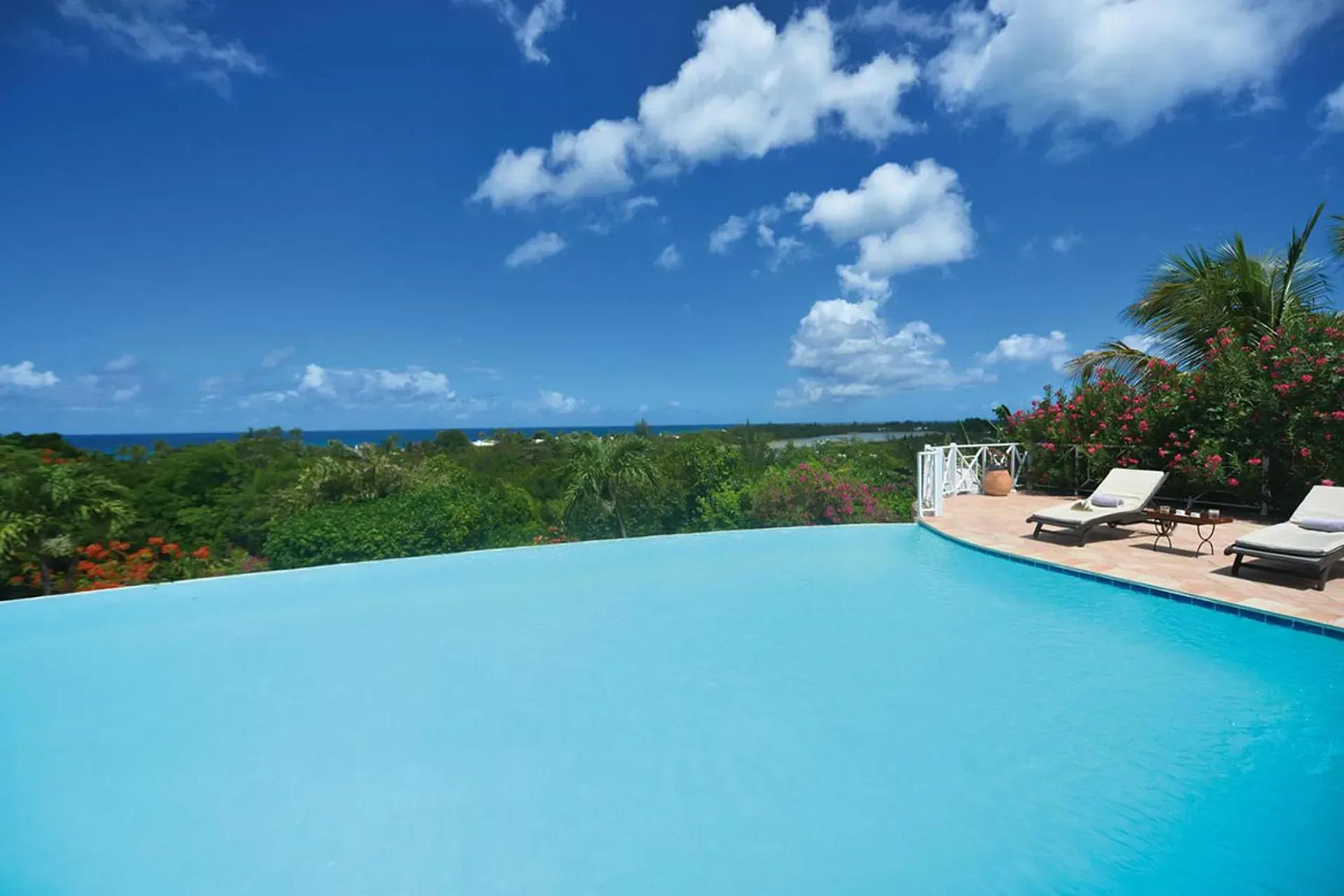 Unwind by the pool with comfortable loungers and tropical ambiance.