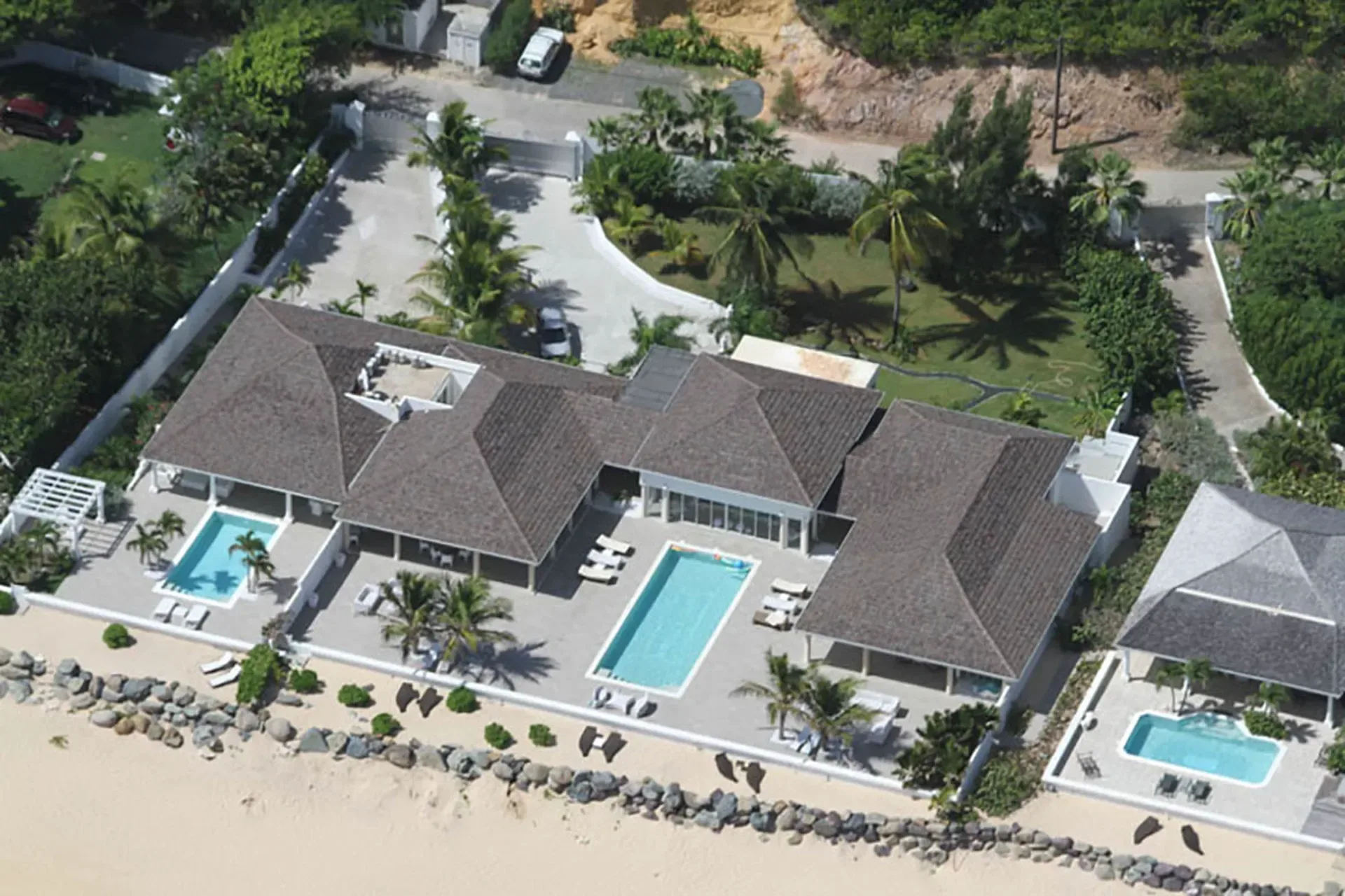 Your own private beachfront estate with multiple pavilions, two pools, and direct beach access in exclusive Terres Basses.