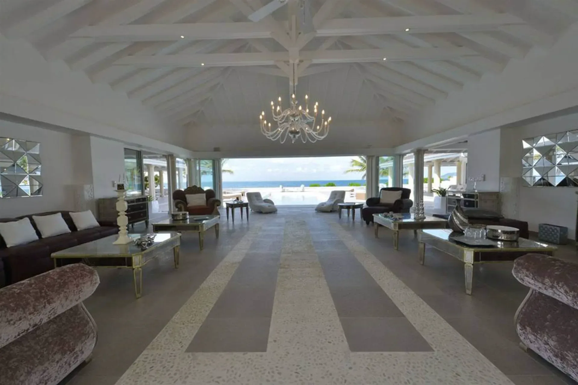 Entertain in grand style with soaring vaulted ceilings, crystal chandelier, and seamless indoor-outdoor flow to your pool terrace.