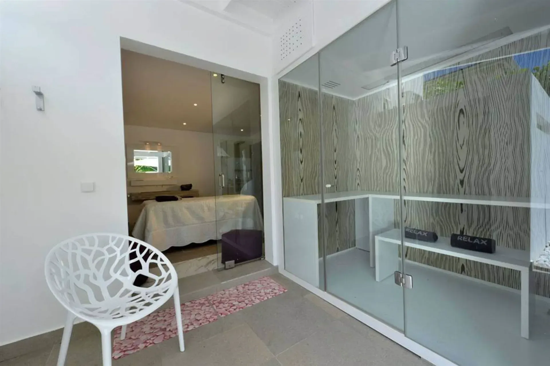 Unwind in your private wellness spa with glass-enclosed steam room and dedicated massage area.