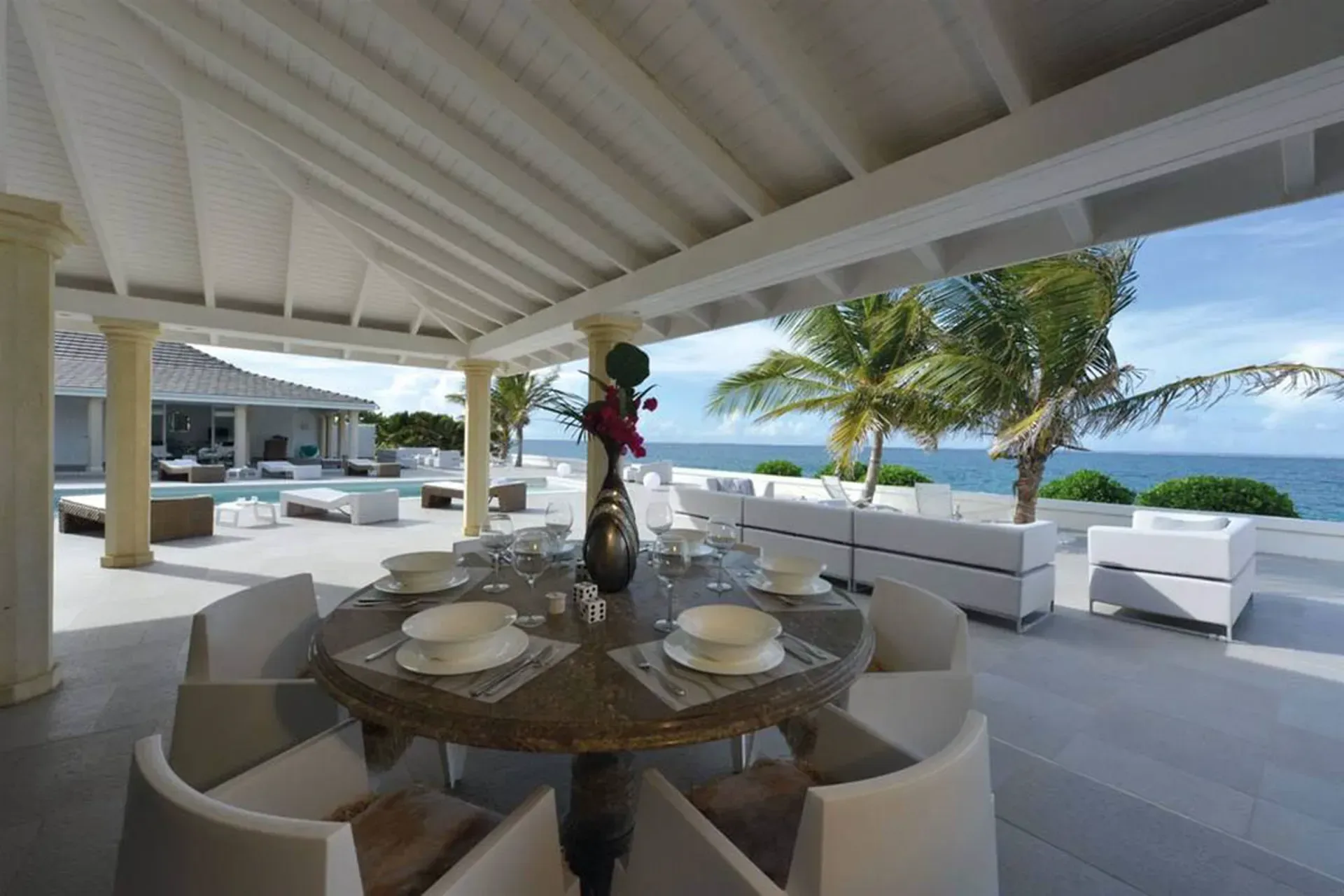 Dine under covered terraces with panoramic ocean views, poolside lounging, and tropical breezes at your private estate.