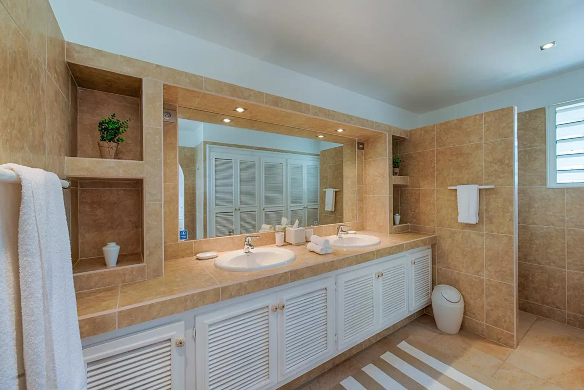 Pamper yourself in a spacious Mediterranean-style bathroom.