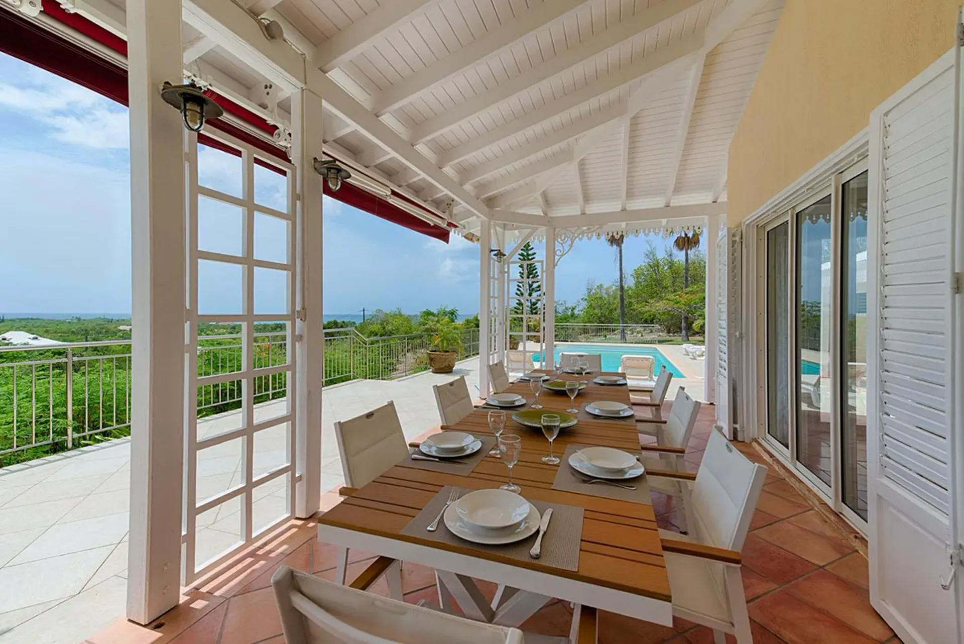 Dine al fresco under covered terraces with stunning pool views.