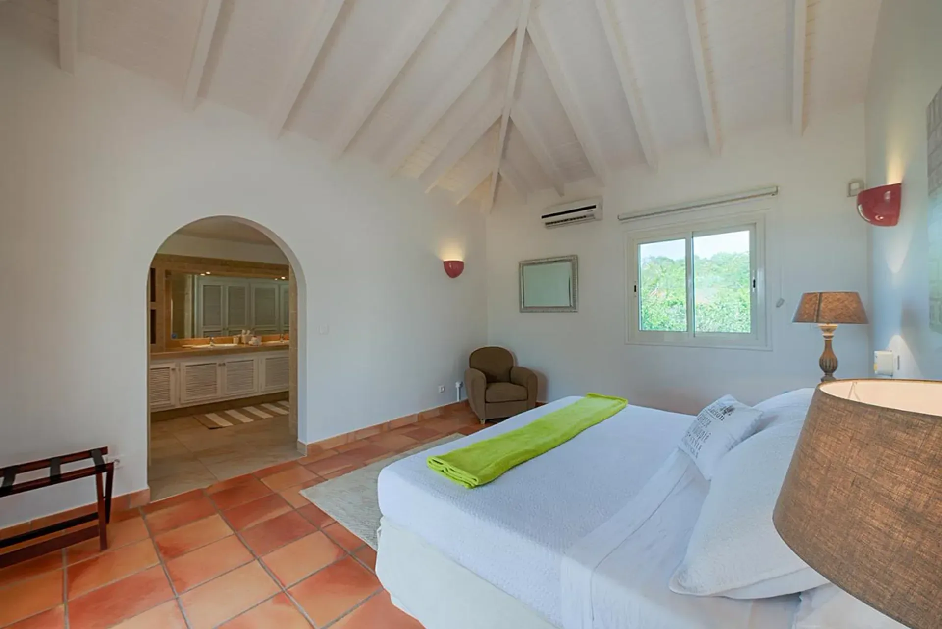 Relax in a bright bedroom with charming arched ensuite.