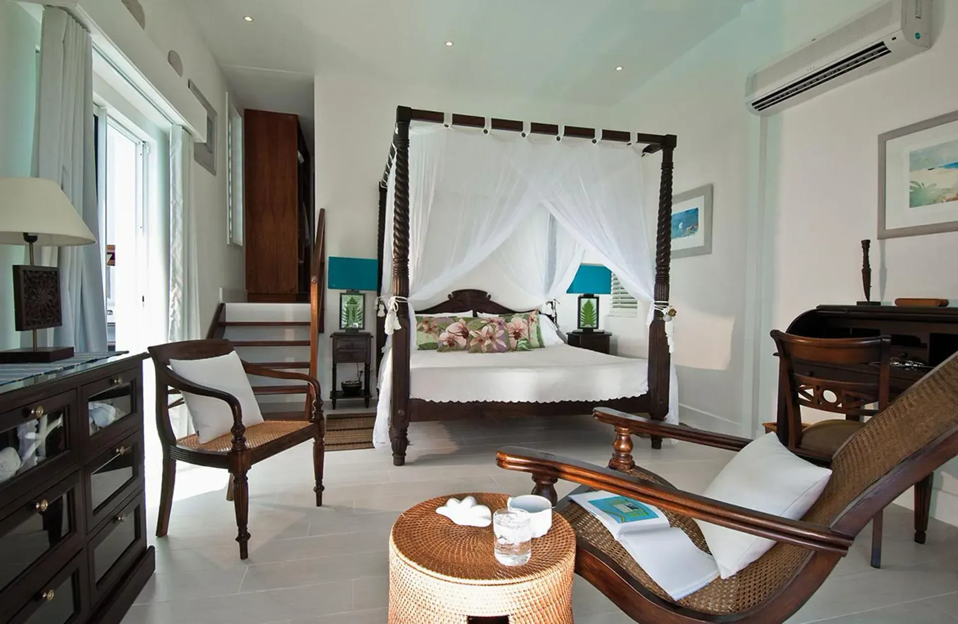Sleep in elegant colonial style with a romantic four-poster canopy bed and tropical decor.