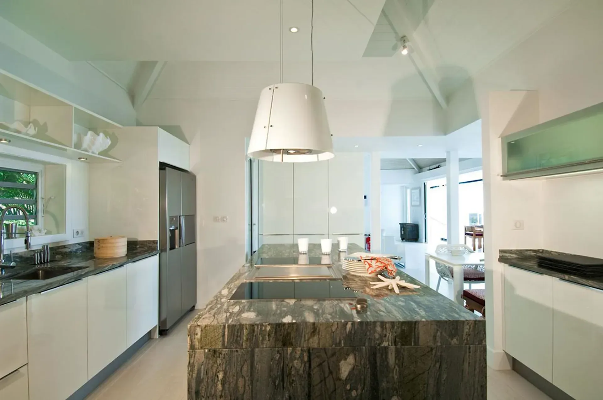 Cook in style in a sleek ultra-modern gourmet kitchen with a stunning marble island.