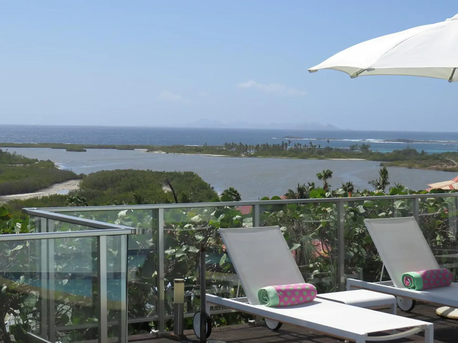 Relax on your private sun deck with panoramic views of the turquoise lagoon and Caribbean Sea.