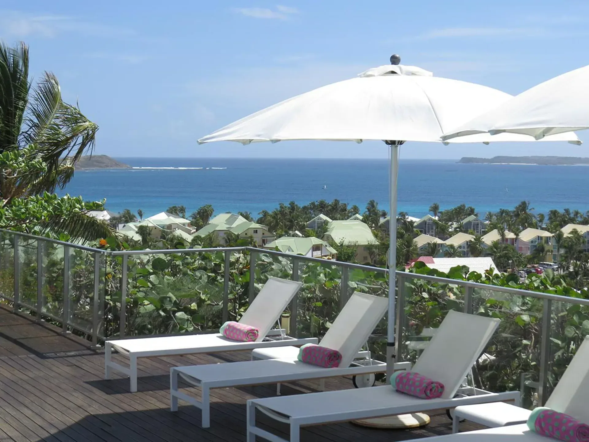 Relax on an elegant sun deck with stunning panoramic views of the turquoise Caribbean Sea.