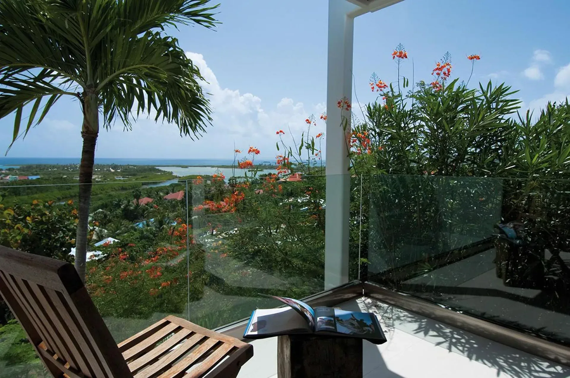 Find your perfect reading spot on a private terrace with panoramic bay views and lush tropical gardens.