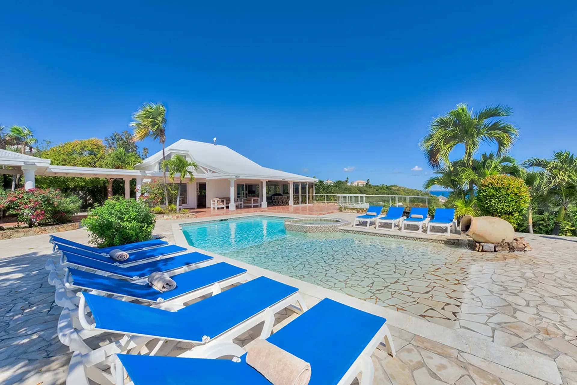 Relax on the spacious pool deck surrounded by tropical beauty.