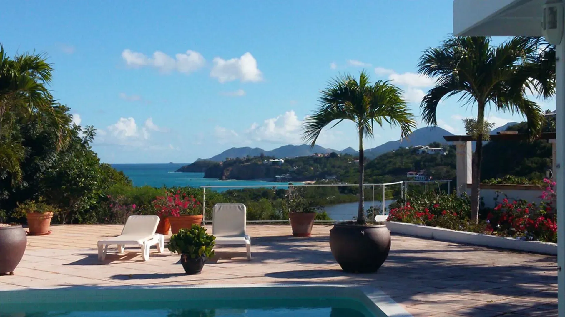 Relax by your pool with panoramic Caribbean views, swaying palms, and vibrant bougainvillea from your private terrace.